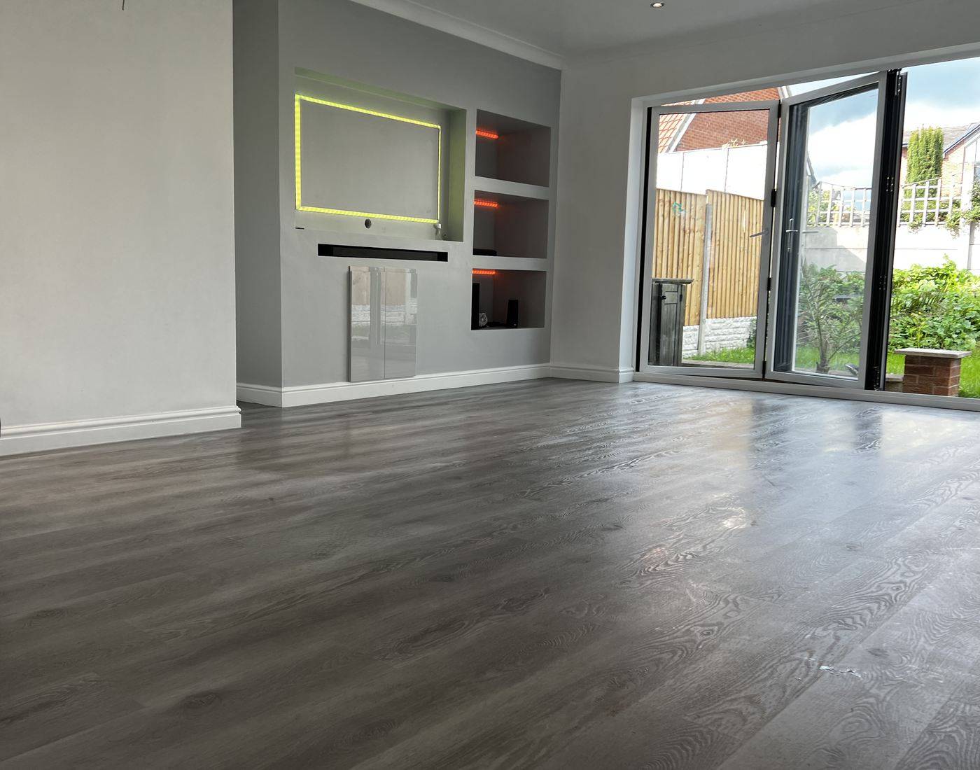 A completed open-plan living room, decorated and floored throughout