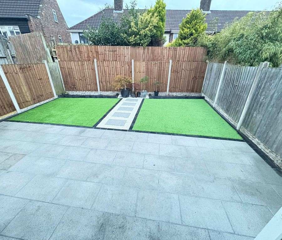 A landscaped rear garden with porcelain paving, lawn and new fencing