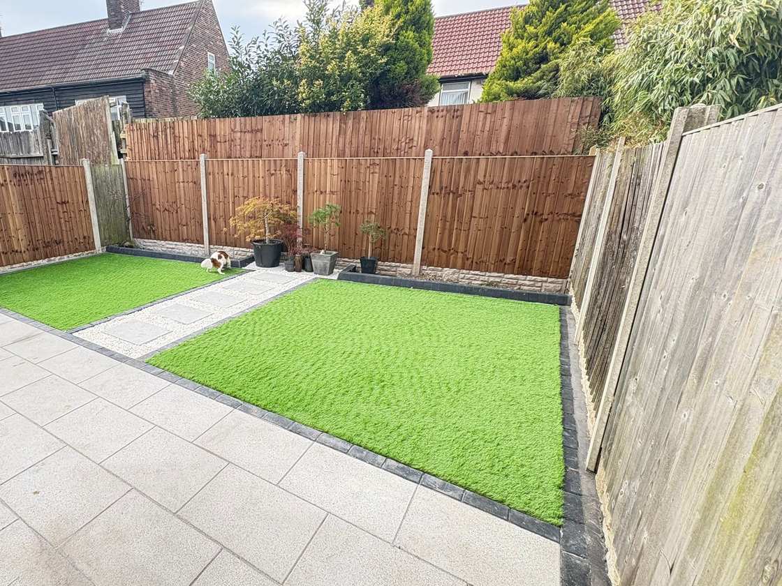 Rear garden with porcelain paving, lawn, stepping stones and new fence panels